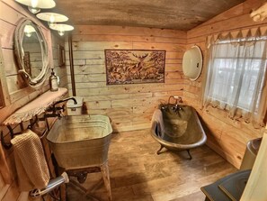 Full bathroom with antique galvanized clawfoot tub.