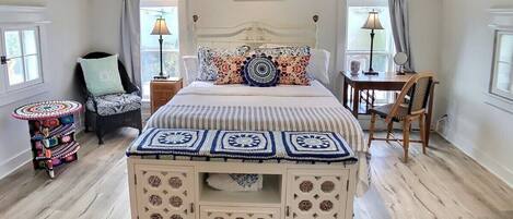 Queen size Tempurpedic bed surrounded by crochet creations made by local artist Gina Gallina.