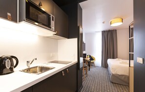 The kitchenette features all the necessary appliances.