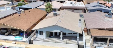 Viewed from above, the house presents a picturesque scene nestled within its canal surrounding.