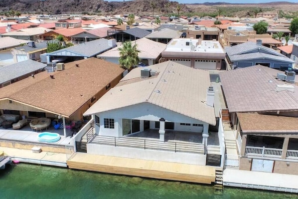 Viewed from above, the house presents a picturesque scene nestled within its canal surrounding.