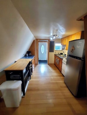 Looking from living room to kitchen and to the front entry area/mud/laundry room