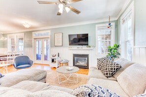 Main level family room with sectional, TV, and fireplace