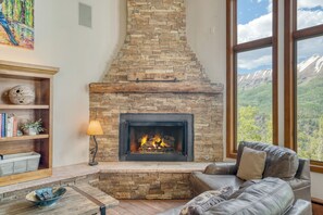 Main living room features a stone fireplace.