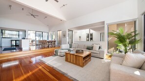 Step into our inviting living room, featuring a plush sofa adorned with soft throw pillows.