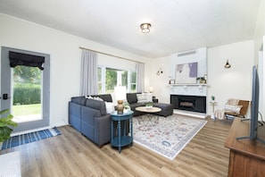 Relax in this bright & cozy living room featuring a plush sectional, smart TV, and charming fireplace 🛋️🔥 Perfect for movie nights, board games, or curling up with a book 📚✨