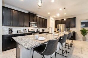 Modern kitchen with granite island and sleek appliances, perfect for culinary adventures and social gatherings.