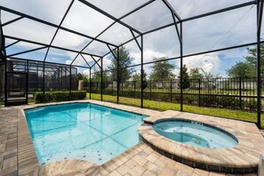 Relax in your private screened pool and hot tub oasis, perfect for a sunny day retreat.