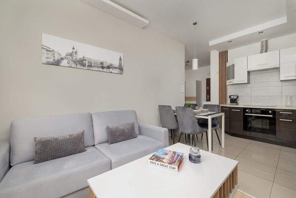 A modern living room with a gray sofa, coffee table, and a bright, open-concept design.

