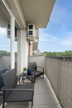 A balcony with seating, offering a peaceful spot to enjoy the surrounding views.

