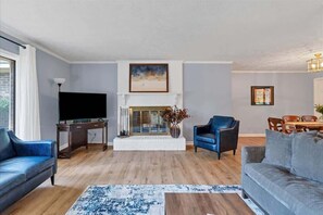 Living room with tons of comfortable seating and a smart TV