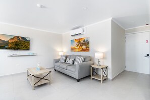 Splendid Living area of the 2-BR Condo in Noord, Aruba - Cosy sofas - Luxuriously designed living area of the apartment - Fabulous sitting space with comfort  - Availability of TV and Netflix - Majestic table lamps - Aesthetic large wall painting