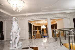 Imposing marble statue of Bacchus overlooking the lower chamber: Peacock Mansion