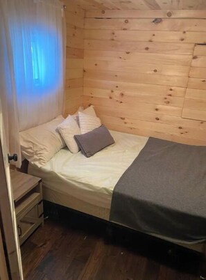 Bedroom #1 c/w queen bed, nightstand and armoire. Also outlet for devices.