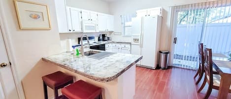 Bright kitchen with all the supplies needed to cook and stay in.