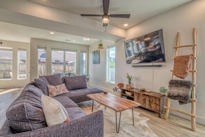 Relax in a cozy living room with plush seating and warm lighting.