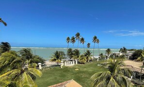 View of the right side of the beach and ocean from the roof deck.