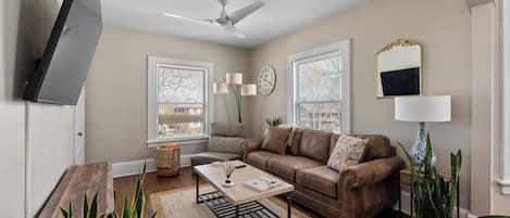 The living room features leather couches & tons of natural light! 