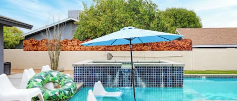 Hot tub and shaded seats on the pool sun shelf.