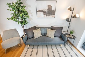 Cozy living room with a sofa bed, offering a relaxed space to unwind and a convenient option for extra sleeping arrangements.
