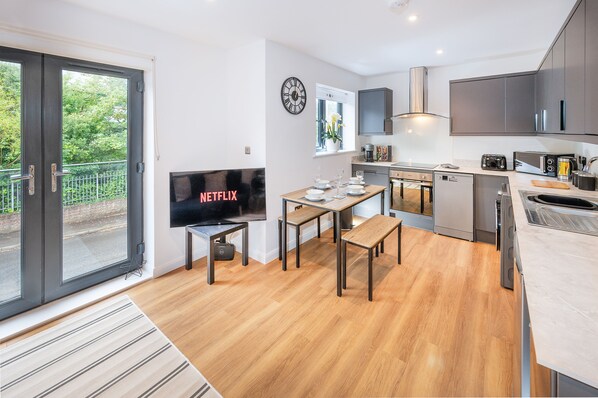 Bright dining area with a TV, creating the perfect space to enjoy meals and unwind with your favorite shows.
