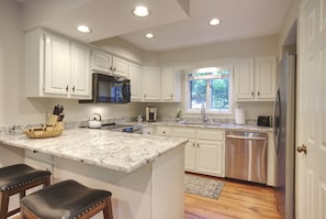 White kitchen cabinetry and granite countertops
