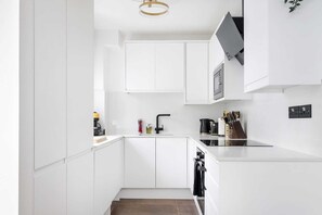 A symphony of clean lines and sleek surfaces, this modern kitchen is a minimalist's dream, offering both visual appeal and high functionality for culinary enthusiasts