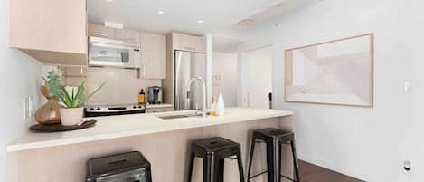 The kitchen features a spacious bar and modern appliances.