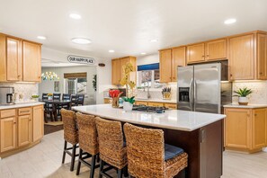 Modern eat-in kitchen with full size refrigerator, dishwasher and microwave