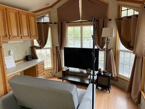 Living room with smart tv, and a couch/couch bed