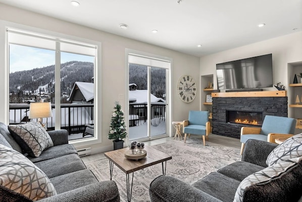 The main living space has a 65" smart tv and a bluetooth sound bar. Guests can connect to it and listen to music while enjoying some family and friend time in the cozy setting by the gas fire place. 