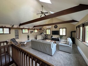 3rd floor living room with TV, Bar, Board Games, and Vaulted ceilings 