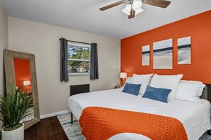 Indulge in the master bedroom oasis featuring blackout curtains for uninterrupted rest, a full-length mirror, in-room coffee bar, and attached bathroom for ultimate comfort and convenience.