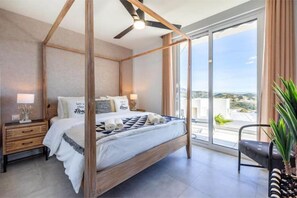 Master bedroom with modern 4 poster bed and ceiling fan