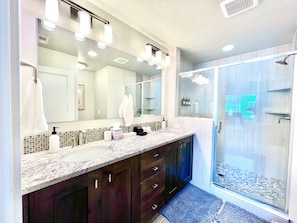 Dual Vanity with walk in shower in one of the primary bathrooms