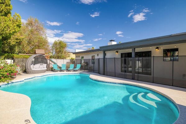 Large pool is surrounded by fencing for additional safety and security.