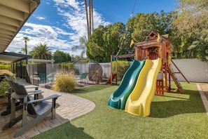 Play area perfect for children is kept separate from the pool by safety fencing.