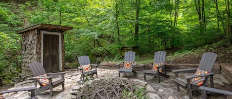 Behind the home is a beautiful firepit tucked into the hillside