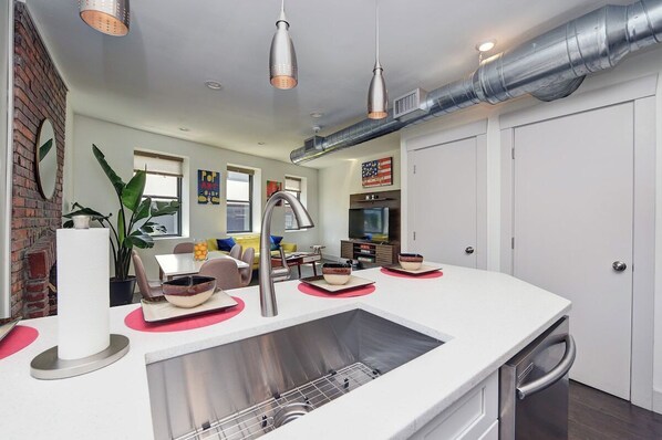 second level full kitchen looking into the common area