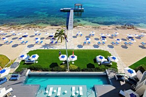 View of the resort's oceanfront pool deck. The resort's dock is equipped with a water ladder for gentle water entry and a cabana for shade. 