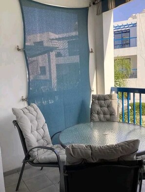 Relax dine/drink with pool view on the Balcony with comfortable chairs to relax
