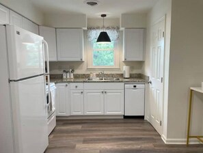 Large kitchen fully stocked to prepare meals.