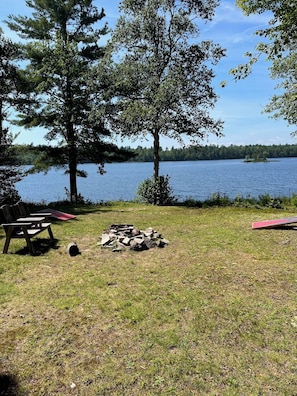 Fire pit, grill, horseshoes, croquet set, and corn hole in yard