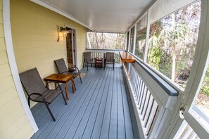 The large screened porch is a great place for you to relax and enjoy a drink.