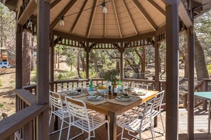 Enjoy dinner on the deck under the gazebo.