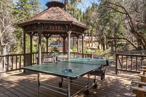 Your spacious deck comes equipped with a gazebo, ping pong table, and lounge chairs.