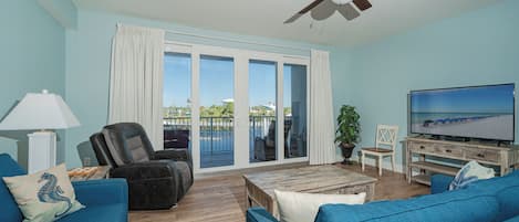 Open Concept Living Area with Sleeper Sofa, Flat Screen TV, Lake Views and Balcony Access