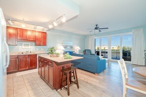 Fully Stocked Kitchen with Drip Coffee Maker and Island Bar Seating