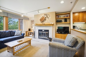 Spacious living room with soothing bright colors.  Natural light from the large windows which offer a serene views of the surrounding landscaping of Highridge