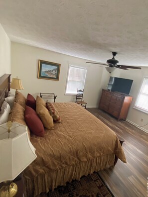 Master bedroom with king bed, TV and private bathroom.